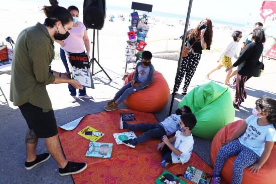 Niños y niñas disfrutando de cuentos en plena Avenida del Mar. 